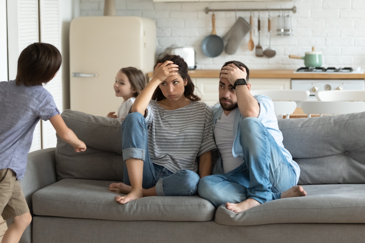 Optimized-Canva - Stressed young parents tired of crazy loud children. Optimized-Canva - Stressed young parents tired of crazy loud children.